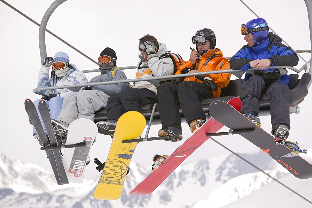 Skiers on a ski lift in the Andorran ski resort of Soldeu, Andorra, Europe