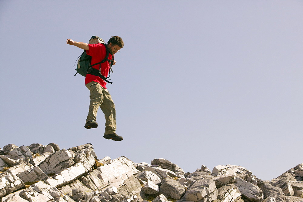 A climber jumping on Aonach Beag near Fort William, Scotland, United Kingdom, Europe