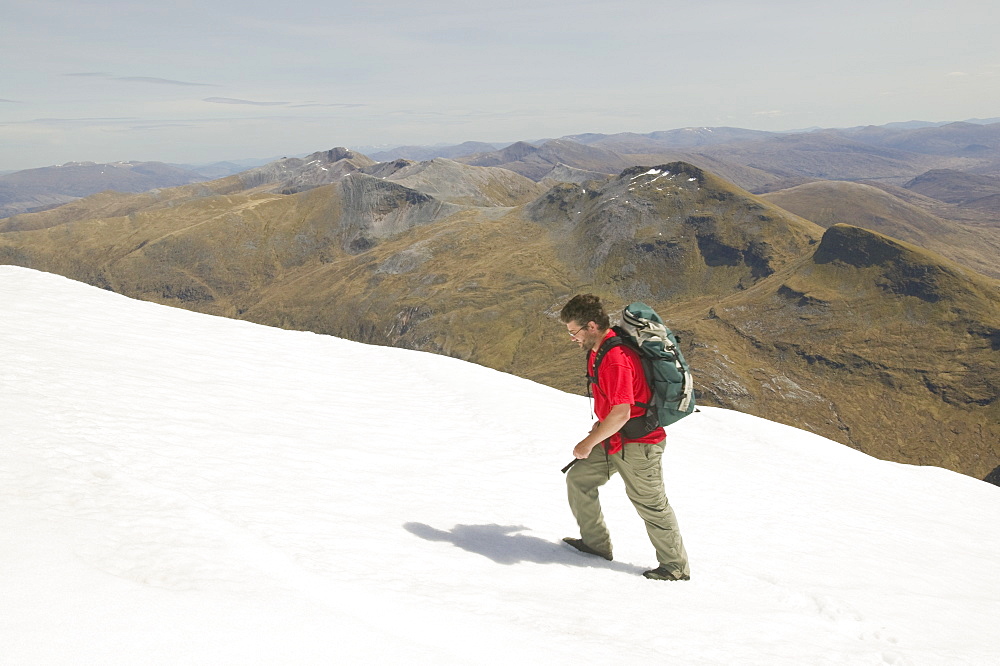 The Grey Corries from Aonach Beag with a hill walker in the snow, Scotland, United Kingdom, Europe