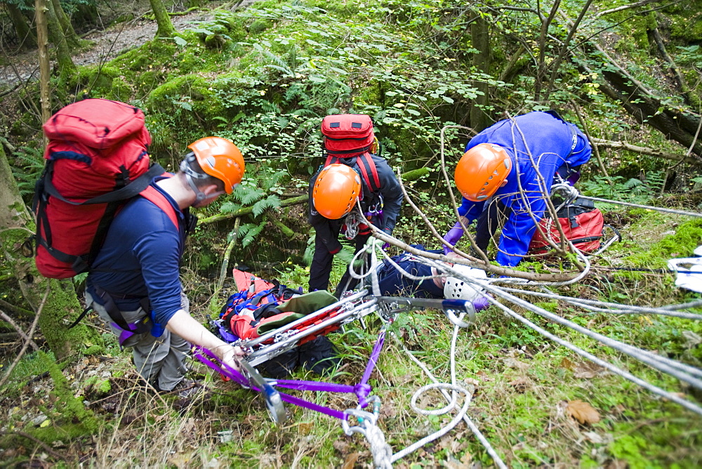 Members of the Langdale Ambleside Mountain Rescue Team treat an injured walker in the Lake District, Cumbria, England, United Kingdom, Europe