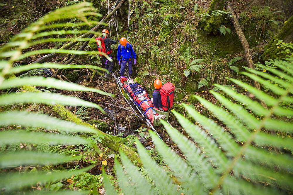 Members of the Langdale Ambleside Mountain Rescue Team treat an injured walker in the Lake District, Cumbria, England, United Kingdom, Europe