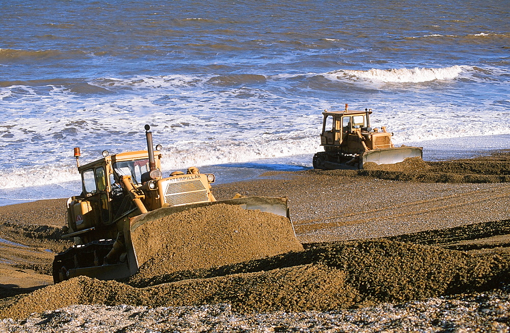 Bulldozers rebuilding the storm beach in Cley, Norfolk, England, United Kingdom, Europe