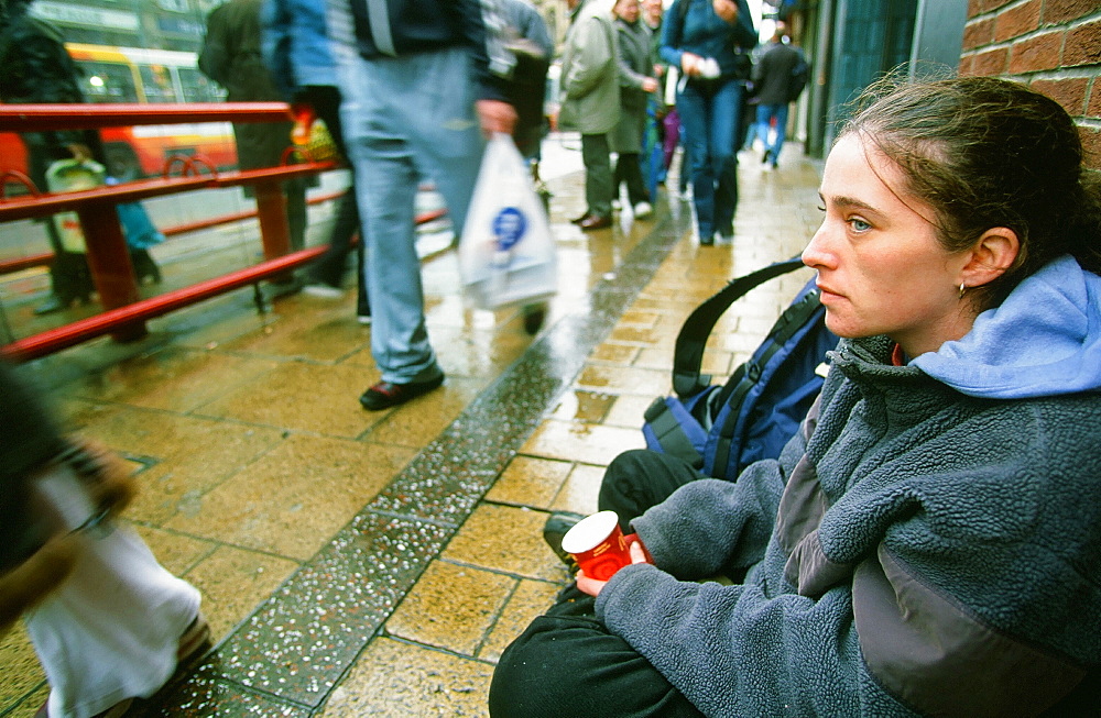 A homeless woman sleeping rough and begging on the streets of Leeds, Yorkshire, England, United Kingdom, Europe