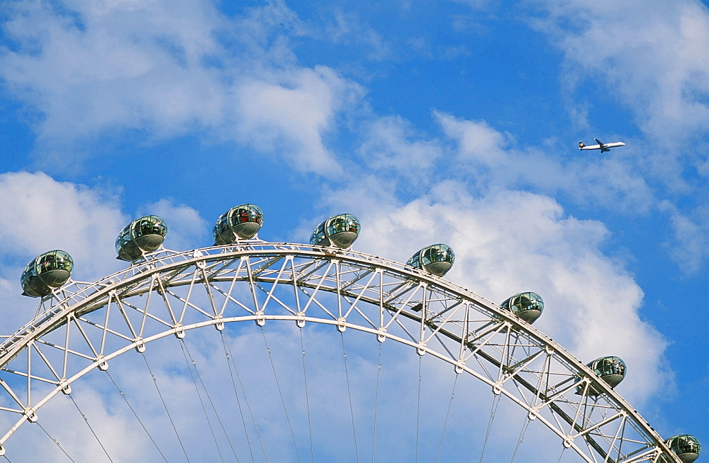 A plane flying over the London Eye, London, England, United Kingdom, Europe