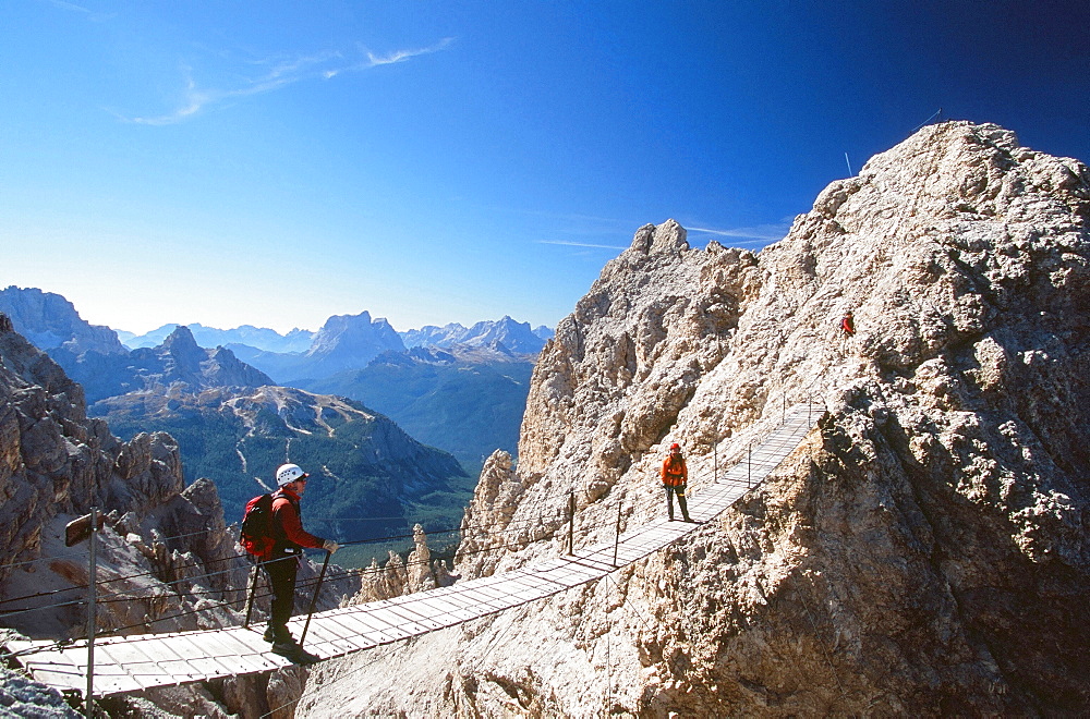 A mountaineer on a Via Ferrata bridge in the Italian Dolomites, Italy, Europe