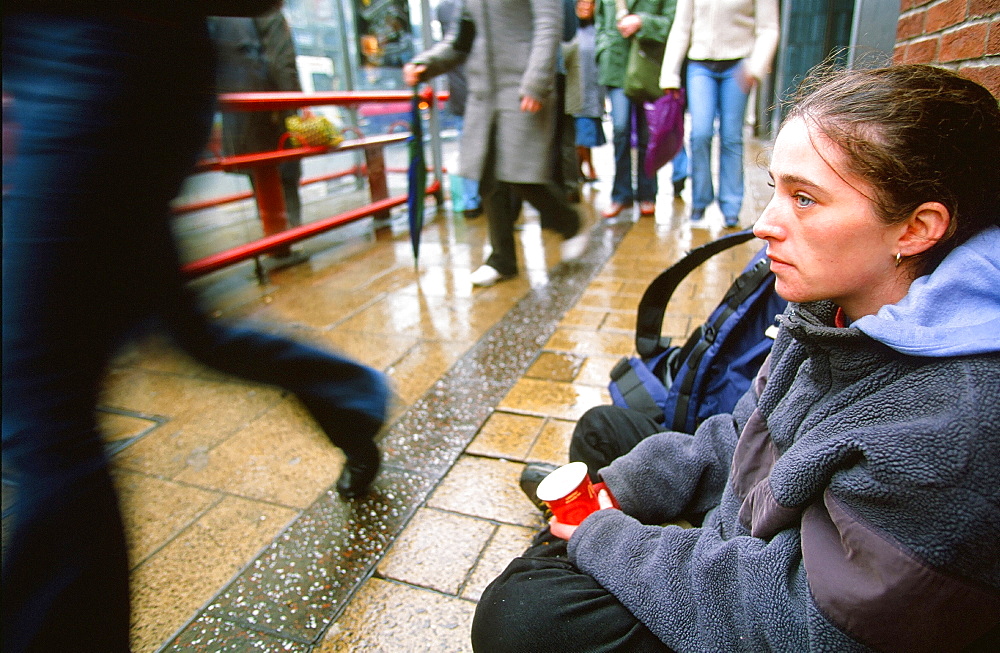 A homeless woman sleeping rough and begging on the streets of Leeds, Yorkshire, England, United Kingdom, Europe