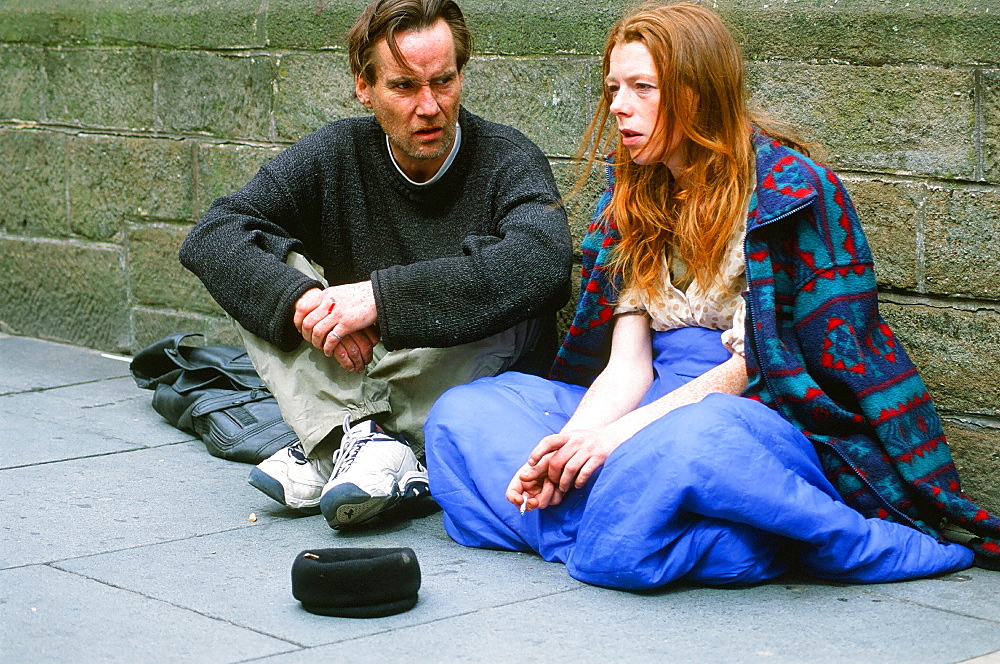 A homeless man and woman sleeping rough and begging on the streets of Leeds, Yorkshire, England, United Kingdom, Europe