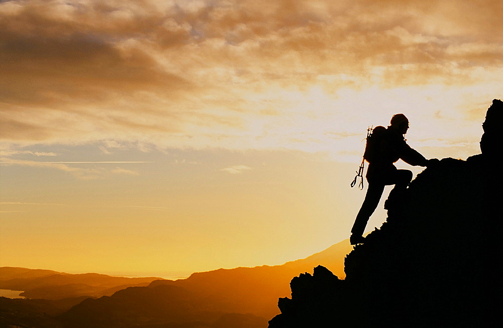 Women scrambling on Fairfield at sunset in the Lake District, England, United Kingdom, Europe