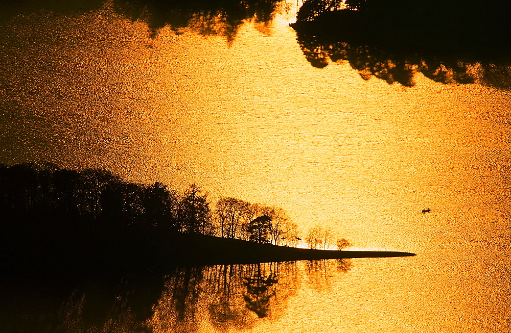 A canoe on Derwent Water at sunset in the Lake District National Park, Cumbria, England, United Kingdom, Europe