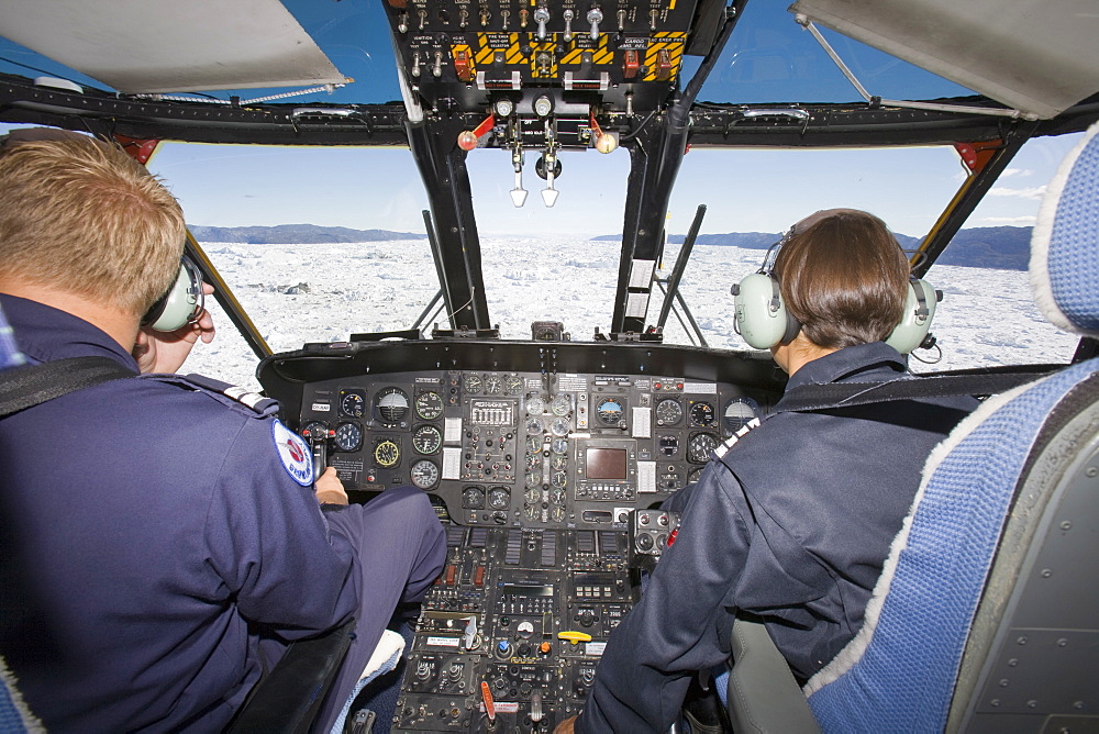 An Air Greenland Sikorsky helicopter flying over the Jacobshavn Icefjord, UNESCO World Heritage Site, near Ilulissat on Greenland, Polar Regions