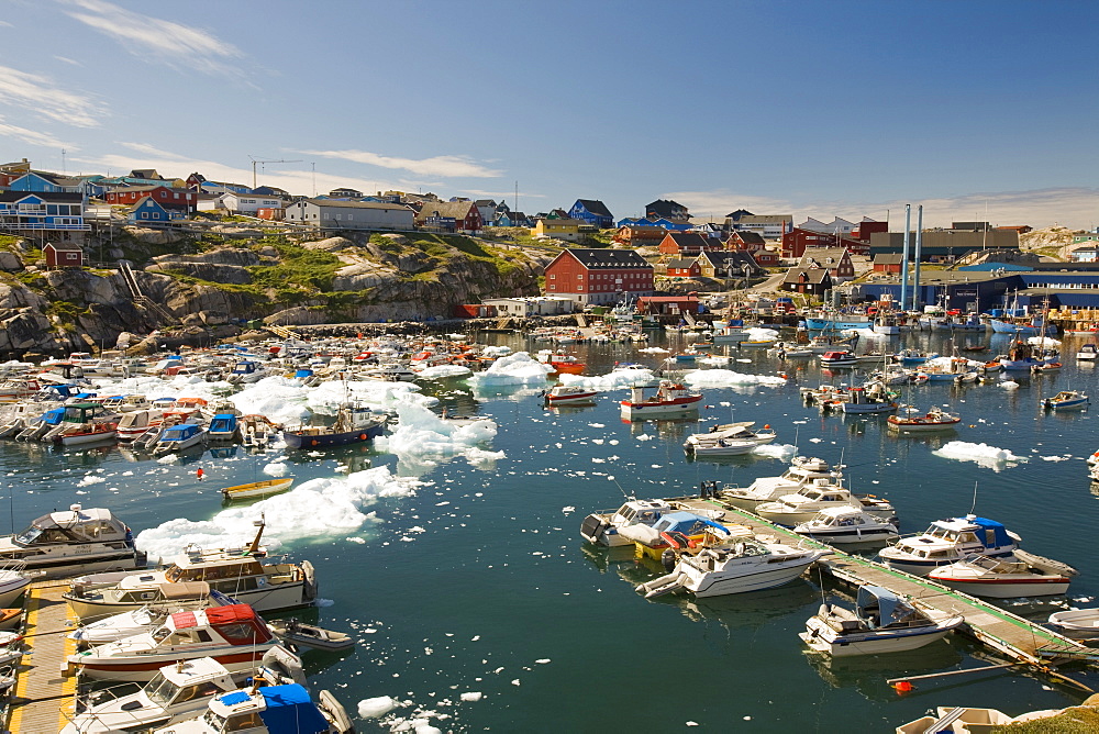 Inuit boats and icebergs in Ilulissat harbour, UNESCO World Heritage Site, Greenland, Polar Regions