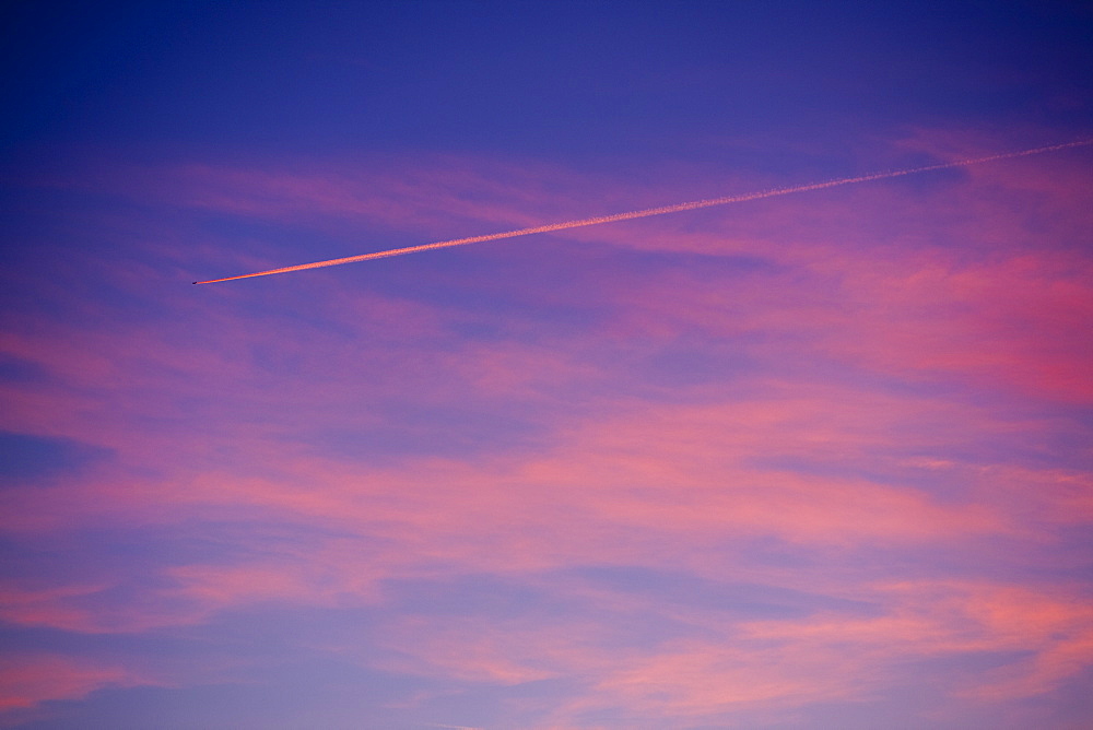 Plane contrail at sunset near Windermere, Lake District, Cumbria, England, United Kingdom, Europe