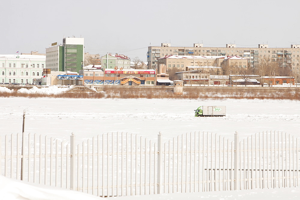 Lorry driving down the frozen Heilongjiang River in the city of Heihe on the Chinese Russian border, Heilongjiang Province, China, Asia