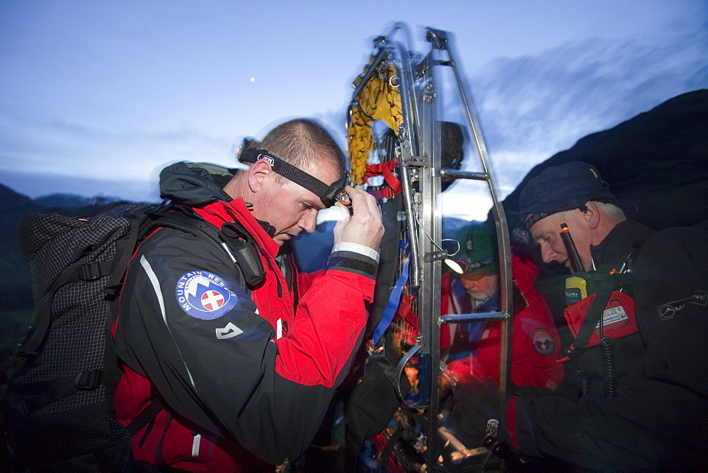 Langdale Ambleside mountain Rescue Team carry an injured walker off the Langdale Pikes at night near Ambleside, Lake District, Cumbria, England, United Kingdom, Europe