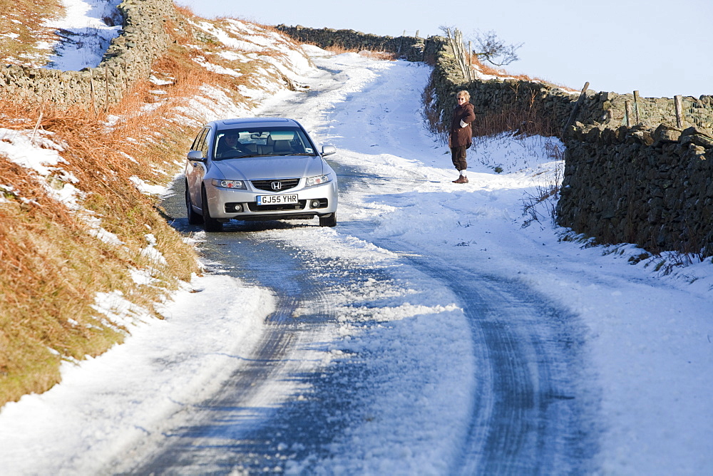 A car stuck in the snow on Kirkstone Pass near Ambleside in the Lake District, Cumbria, England, United Kingdom, Europe