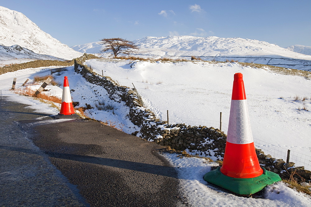 Traffic cones in winter snow on Kirkstone Pass in the Lake District, Cumbria, England, United Kingdom, Europe