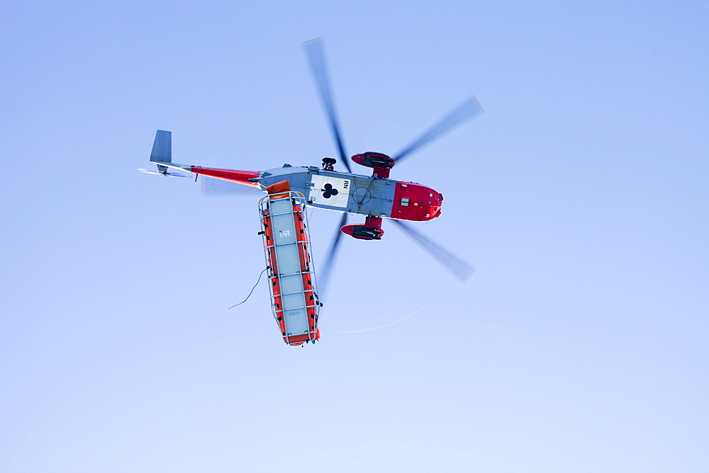 A Navy Sea King helicopter lowers a stretcher to evacuate a seriously injured walker who had fallen 250 feet on Bow Fell in the Lake District, Cumbria, England, United Kingdom, Europe