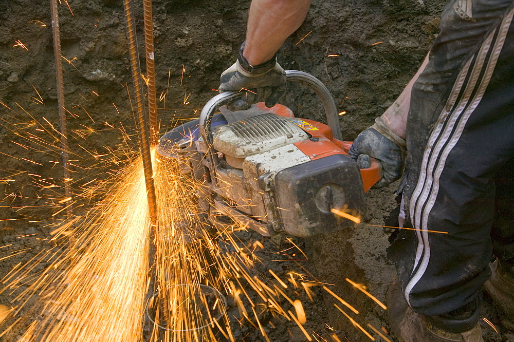 A builder using an angle grinder