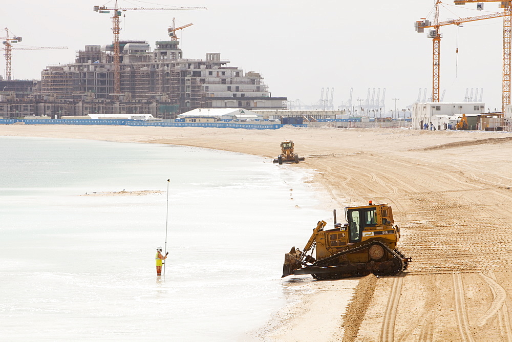 Workers creating a new beach resort on the Palm development in Dubai, United Arab Emirates, Middle East