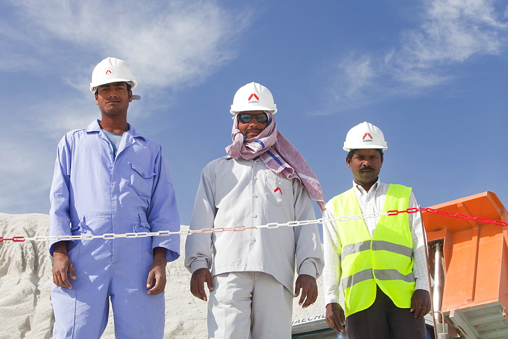 Workers working on reclaiming land from the sea for another exclusive hotel development in Dubai, United Arab Emirates, Middle East