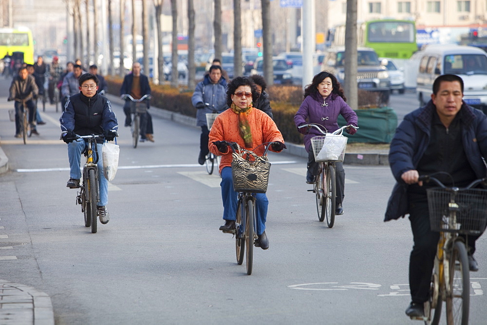 Cyclists and cars in Beijing, China, Asia