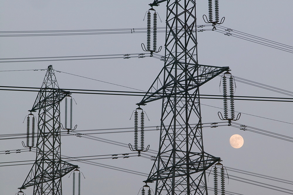 A full moon and electricity pylons in Leicestershire, England, United Kingdom, Europe