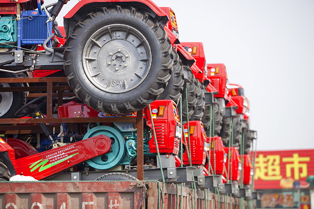 A lorry loaded with cheap new tractors in northern China, Asia