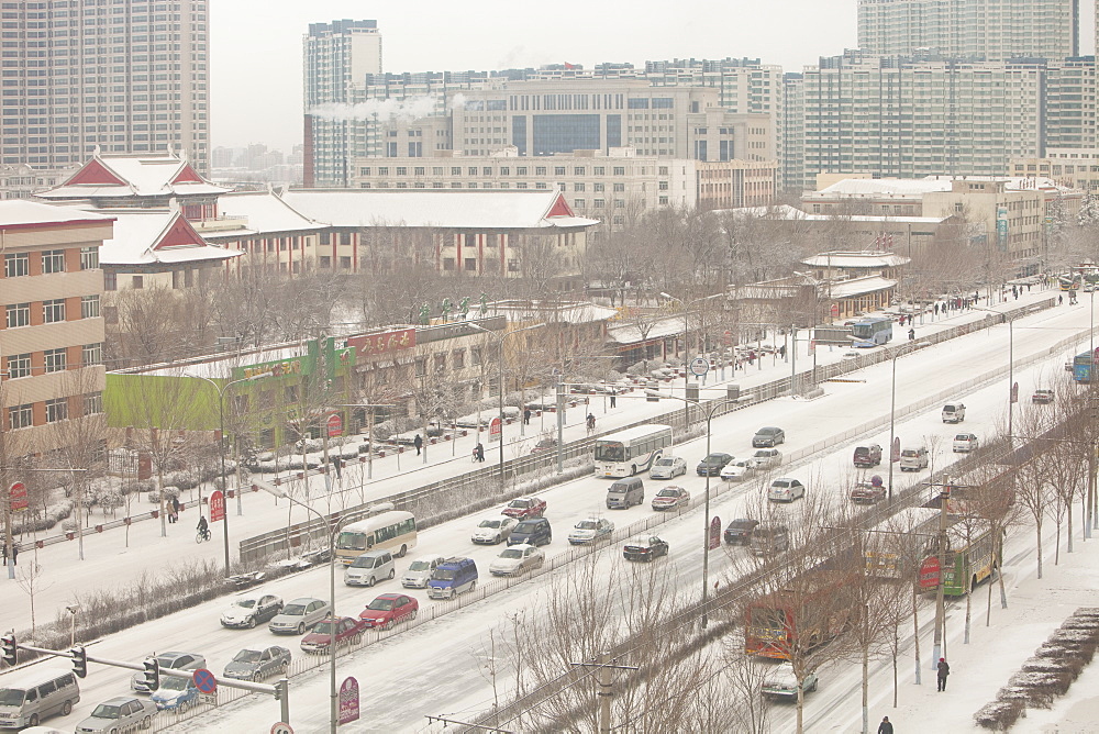 Cars in late winter snowfall in Harbin, Heilongjiang province, China, Asia