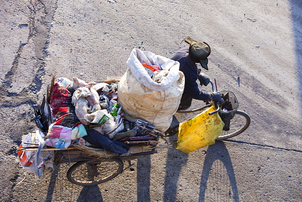 A Chinese peasant recycling rubbish on the streets of Suihua in Heilongjiang Province, Northern China, Asia