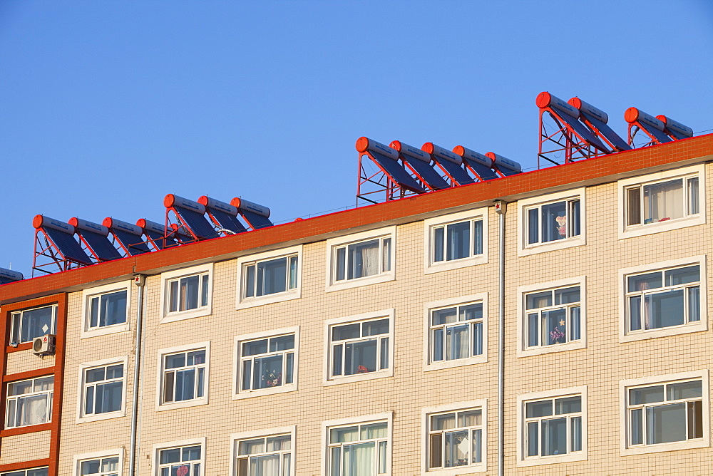 Housing complexes in many cities in northern China have solar water heaters on the roof, China, Asia