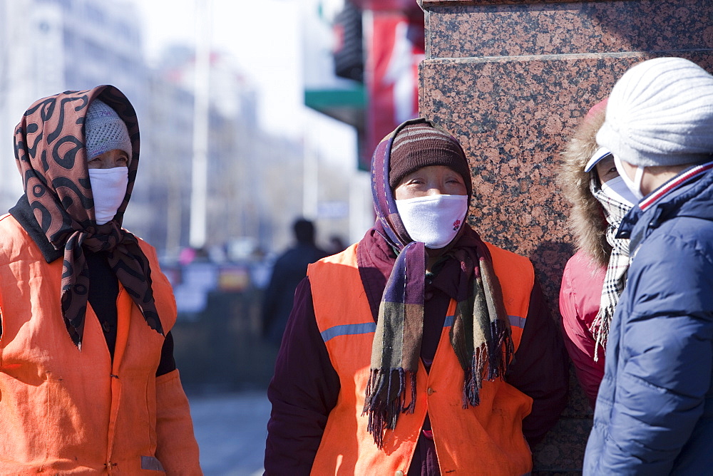 Road sweepers wear a face masks against the awful air pollution in Harbin city, Heilongjiang, Northern China, Asia