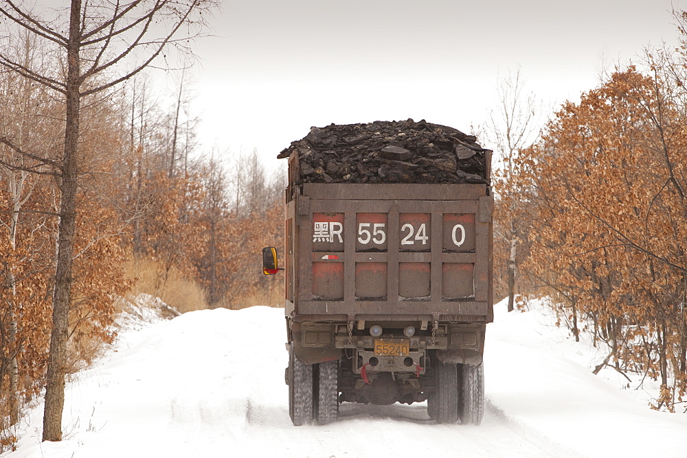 Trucks carrying highly polluting low grade coal from an open cast coal mine near Heihe, Heilongjiang, China, Asia