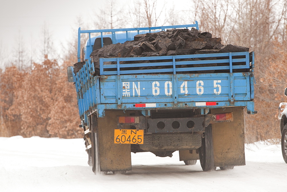 Trucks carrying highly polluting low grade coal from an open cast coal mine near Heihe, Heilongjiang, China, Asia