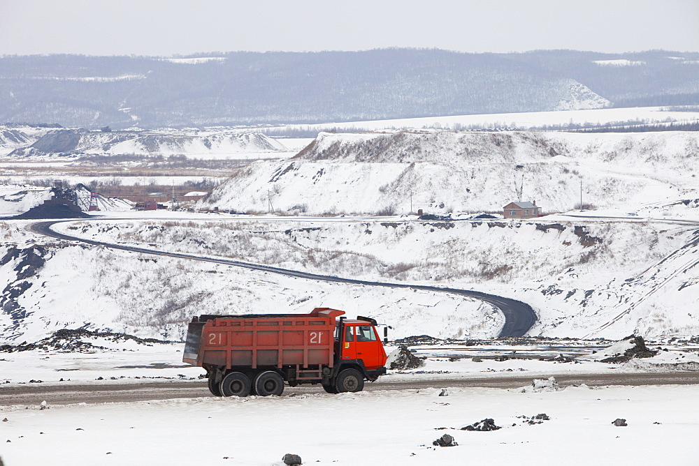 Trucks haul highly polluting low grade coal from an open cast coal mine near Heihe, Heilongjiang province on the Chinese Russian border, China, Asia