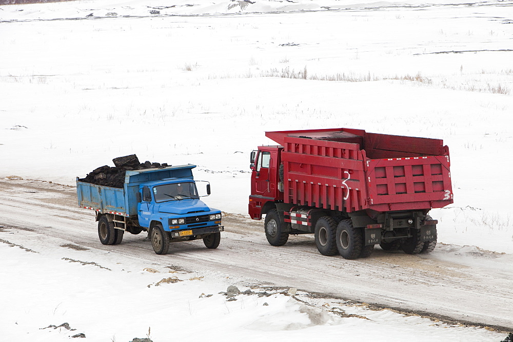 Trucks haul highly polluting low grade coal from an open cast coal mine near Heihe, Heilongjiang province on the Chinese Russian border, China, Asia