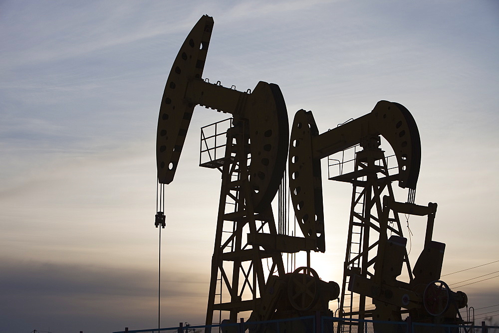 Nodding donkey oil pumps pumping oil up from the Daqing oil field in Northern China, Asia