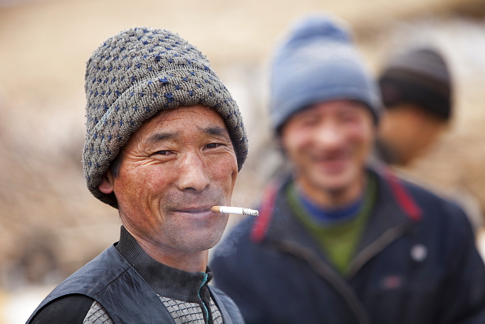 A chinese peasant famer smoking a cigarette in Heilongjiang province in Northern China, Asia