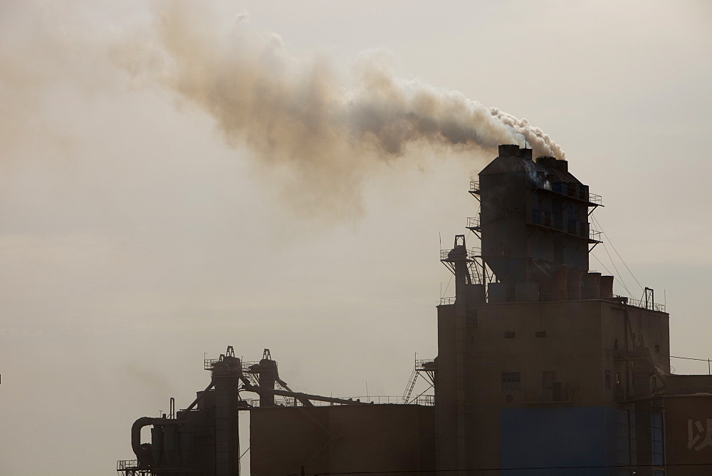 A coal fired cement factory billows smoke in Inner Mongolia, China, Asia