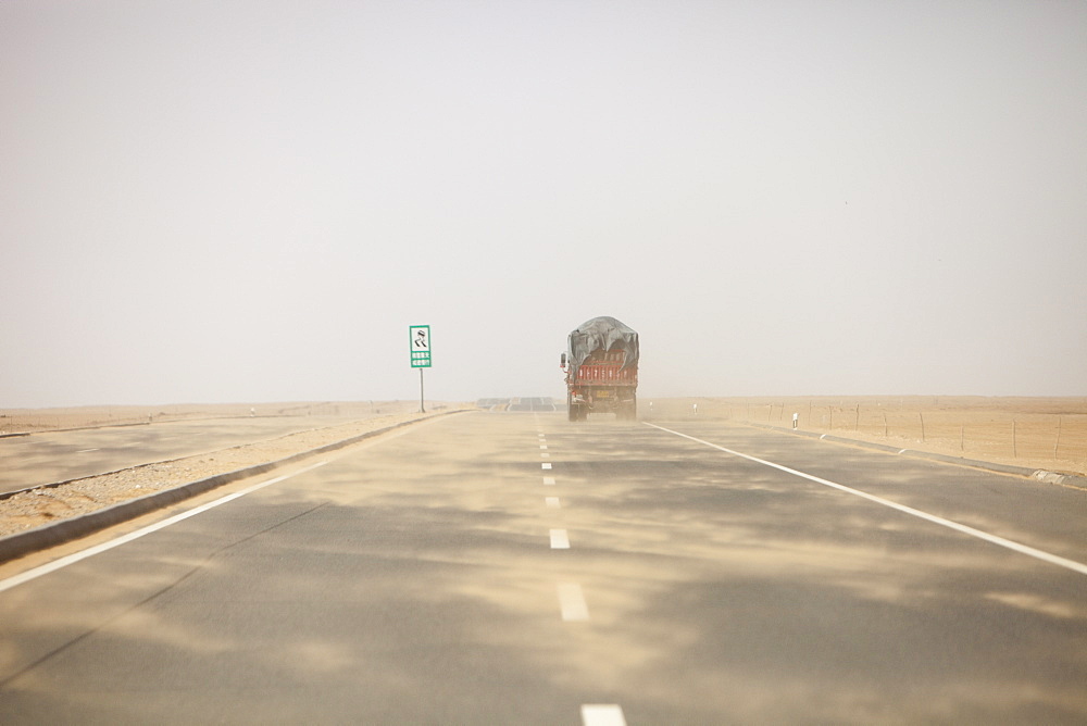 A sand storm sweeps across a highway in Inner Mongolia, China, Asia