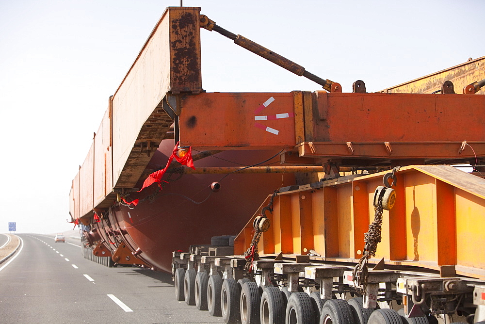 A huge load trundles on a low loader across Inner Mongolia, China, Asia