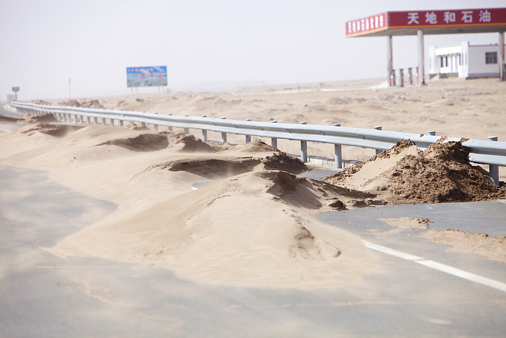 Sand dunes spreading across a highway in Inner Mongolia, China, Asia