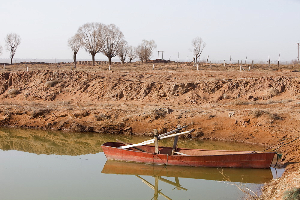 A small reservoir has been dug out in an attempt to find water, the original lake bed level was the highest ground level visible on the picture, Hong Hai Zai, near Dongsheng, Inner Mongolia, China, Asia