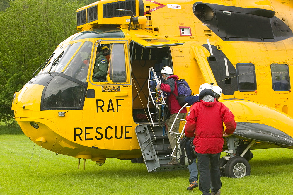 Members of a mountain rescue team board an RAF Sea King Helicopter, Lake District, Cumbria, England, United Kingdom, Europe