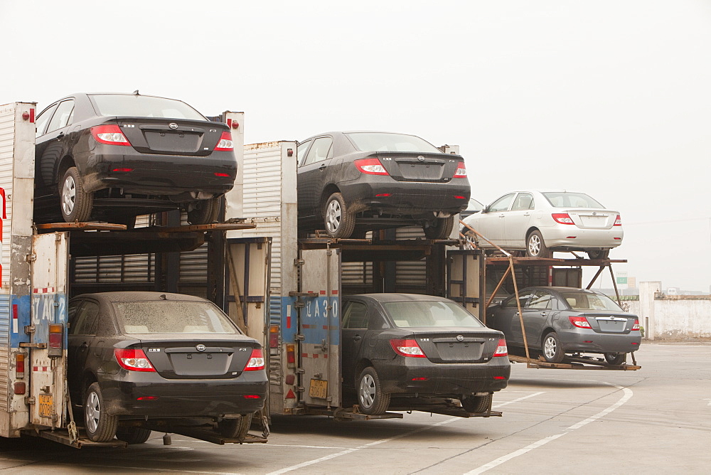 Car transporters loaded with new cars fuel China's ever increasing demand for vehicles, China, Asia