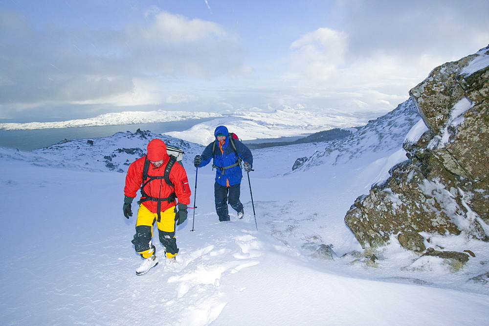 Hikers in a blizzard near the Old Man of Storr on the Isle of Skye, Scotland, United Kingdom, Europe