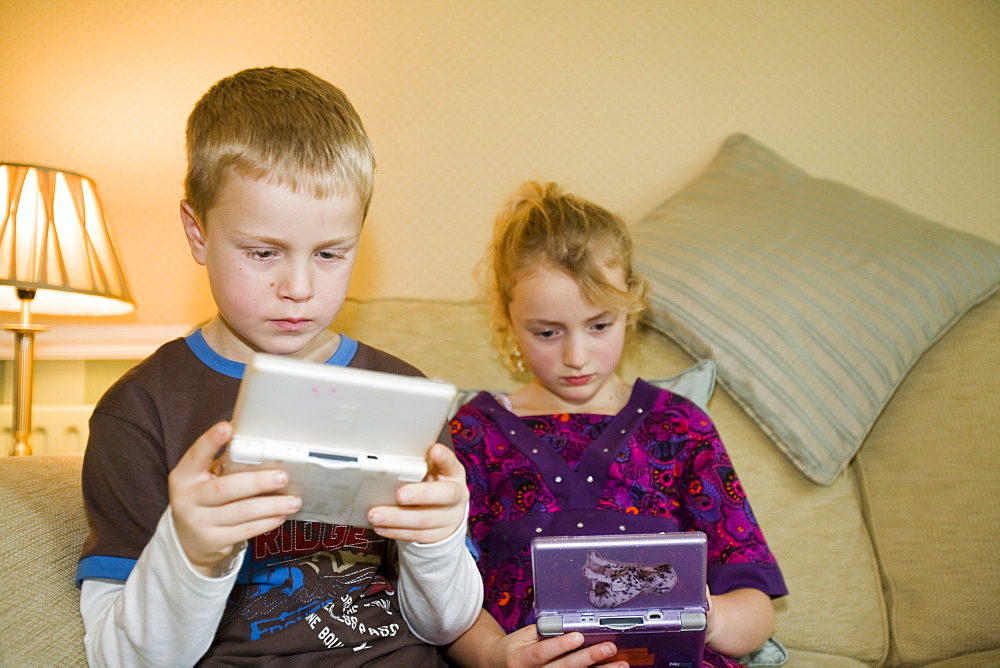 Two children playing computer games on a console