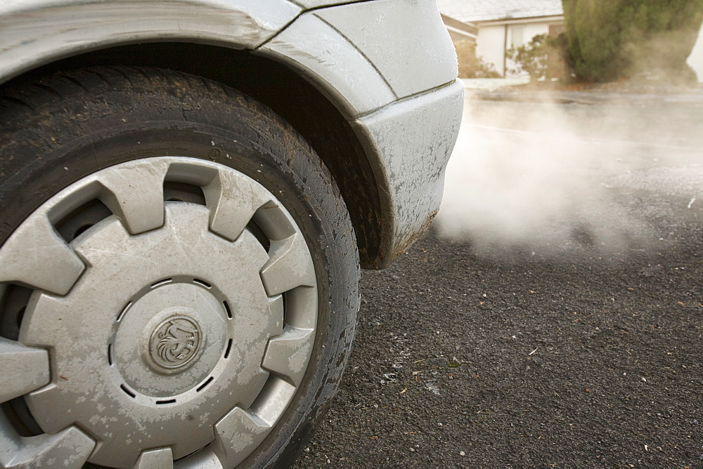 Exhaust fumes from a car exhaust pipe in freezing weather, United Kingdom, Europe