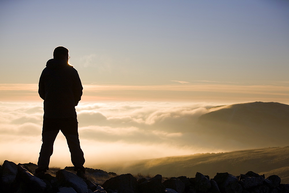 A walker on the summit of Caudale Moor in the Lake District National Park, Cumbria, England, United Kingdom, Europe