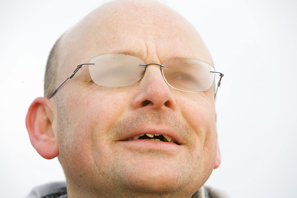 A man with steamed up glasses in cold weather