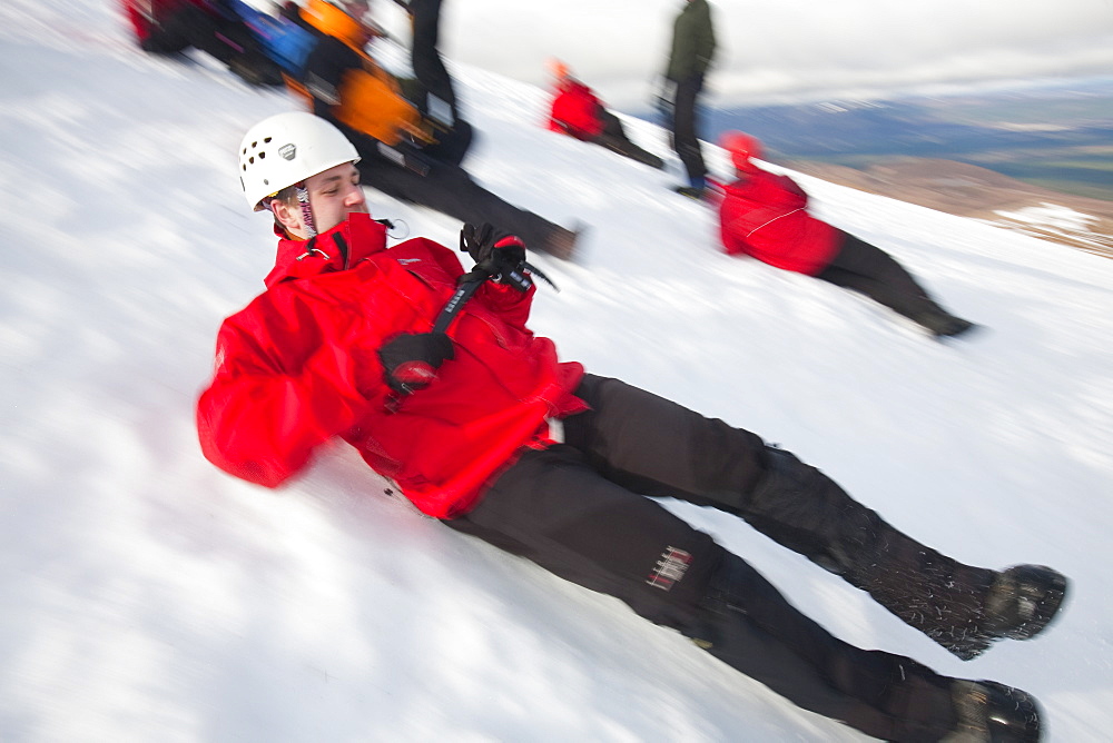 A group of mountaineers practise ice axe arrests on Cairngorm in the Cairngorm National Park in Scotland, United Kingdom, Europe